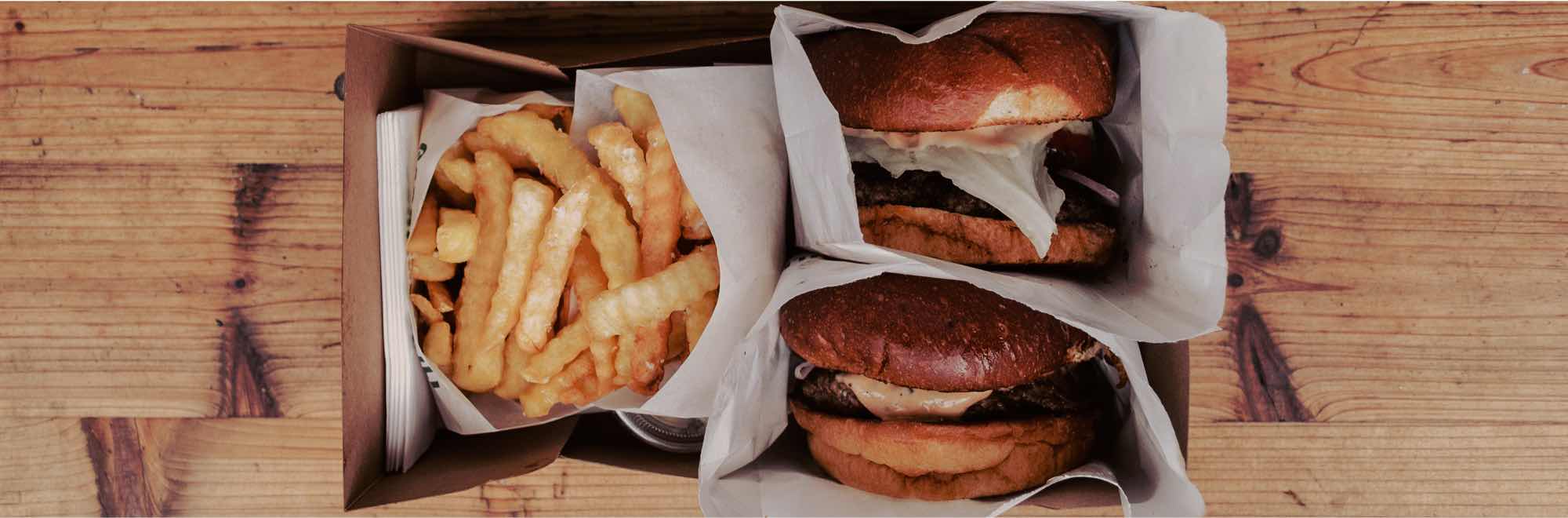 Burger and chips are packaged in a box